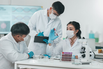 Medical science research team in modern laboratory conducting experiments, analyzing samples under...