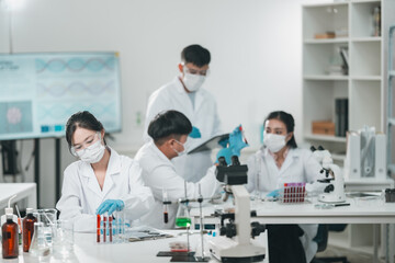 Fototapeta premium Research team working in medical science laboratory to develop innovative cosmetic products through precise analysis experimentation, technology with collaborative scientific methods