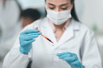 Medical research team conducting health and pharmaceutical experiments using blood samples in laboratory to develop advanced treatments and vaccines for global healthcare innovation