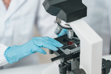 Microscope-focused research in modern laboratory environment, highlighting advancements in medicine technology, experimentation through the precision and dedication of scientist