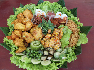 Traditional Side Dishes of yellow rice, A Staple in Indonesian Thanksgiving Ceremonies