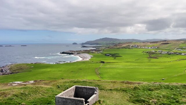 Stationary View of Malin Head&rsquo;s Green Fields and Portmor Beach Under Cloudy Sky