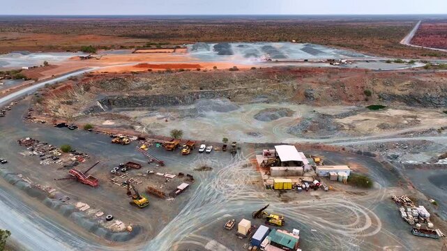 Aerial pan shot of a mining site at Port Headland in Australia with work going on. Trucks and loaders at work.