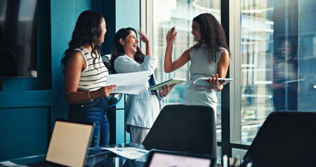 Women, team and high five with celebration at office with support, achievement and tablet at...