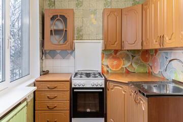the old furniture in the kitchen is not repaired. kitchen with upper and lower cabinets, gas stove....