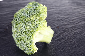 Broccoli isolated isolation on the black SLATE