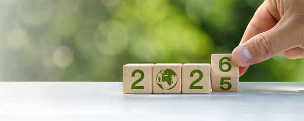 Sustainable development goals 2026 on wooden block background in green forest. Concept, goals,...