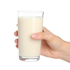 Hand holding glass of light colored liquid against black background concept of consumption and refreshment
