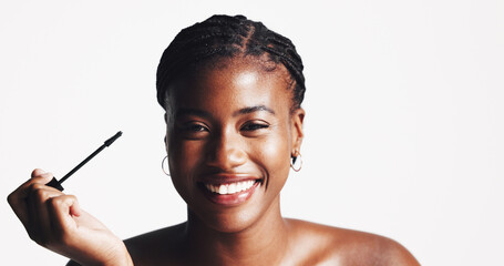 Mascara, space or portrait of black woman with makeup, skincare mockup or beauty in studio on white background. Cosmetics brush, application or girl model with eyelash extensions for volume or length