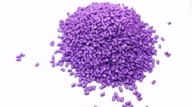video of violet masterbatch granules isolated on white background, video of violet masterbatch granules overlay, suitable as a videography design for industrial plastic company profile.
