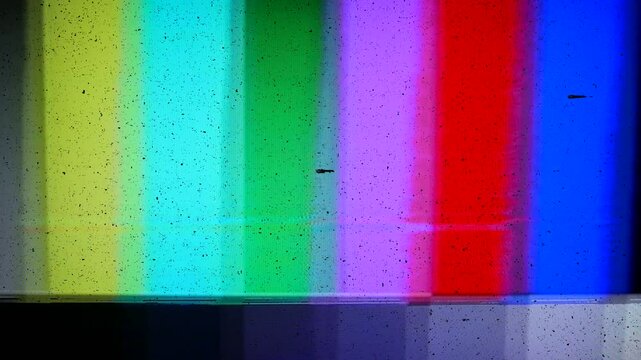 Video noise from a video cassette player. Color bars test pattern. With dark noisy sections and static. Tape damage on authentic analog tape, captured with a 4K camera.