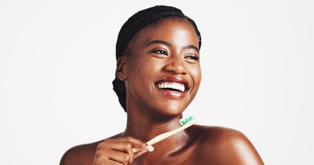 Toothbrush, dental hygiene and happy black woman in studio for wellness, brushing teeth and cleaning. Space, whitening and face of person for oral care, health and grooming on white background