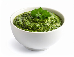 A bowl of chimichurri sauce isolated on a white background