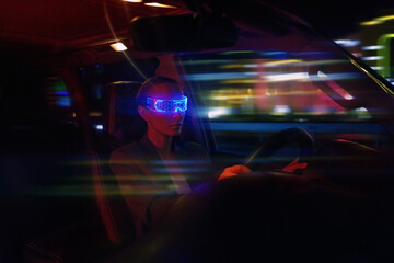 Woman in Futuristic High-tech VR Eyewear driving car in night ci