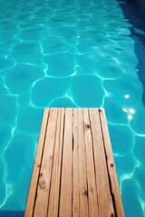 Obraz premium A weathered wooden diving board extends over a tranquil blue swimming pool, ready for a refreshing plunge Sunlight glistens on the water's surface, creating a serene summer scene , splash, wooden