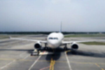Obraz premium blurry airport scene, airplanes are seen parked at a deserted airport, without people, with a blurry airplane background