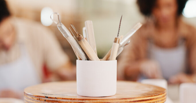 Pottery, art and tools in workshop for process, sculpture design and learning artwork. Closeup, people and artistic equipment for craft production, handmade hobby and creative lesson in ceramic class