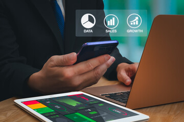 Businessman using digital data analytics interface and financial dashboard on tablet and laptop in  office