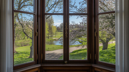 A tranquil view from a window overlooking a lush park