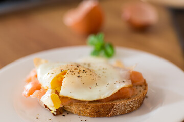 A slice of bread with a cooked egg and lightly salted red fish