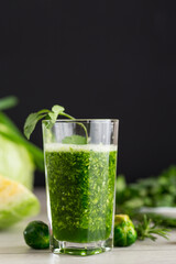Refreshing green smoothie with fresh vegetables and herbs