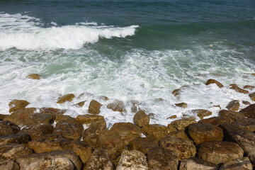beautiful  waves crashing against the rocks of the breakwater