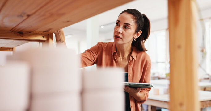 Pottery shelf, tablet and woman in workshop for inventory, inspection and checklist of ceramic designs. Creative business, art studio and person on digital tech for DIY hobby, planning and website