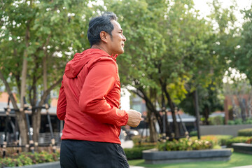 Senior old man runner exercise outdoor nature park. fitness man jogging wearing sportswear. Mature athlete man in sportswear Workout running at public park. Health and activity old man lifestyle