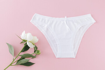 White cotton women's panties on the pink background.