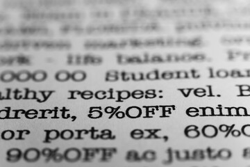 5 percent off. Text printed on a page. A piece of paper with a phrase. Marketing.