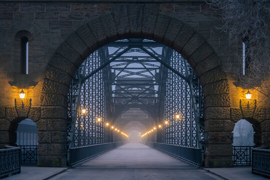 Historic iron and stone bridge in Harburg, Hamburg during winter evening