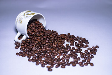 Closeup view of coffee beans and cup on table