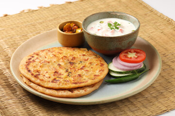 Indian traditional breakfast food aloo paratha is a potato  flatbread served with curd