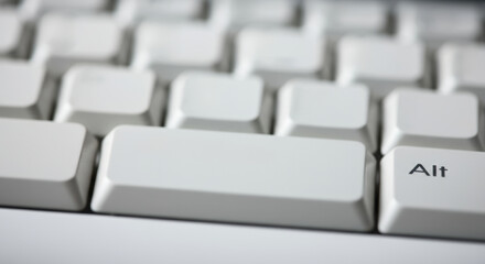 Close-up of a white computer keyboard highlighting the Alt key