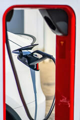 Detail of a connected charging station for a electric car. Charging an electric car at an outdoor charging station.