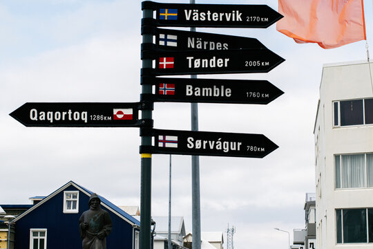 Directional signpost in Akranes Iceland showing distances with national flags
