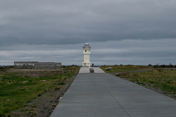 Lighthouse in Akranes Iceland with paved walkway and overcast sky