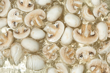 Raw White Mushrooms Champignons Close-Up Splash in a Water Top View