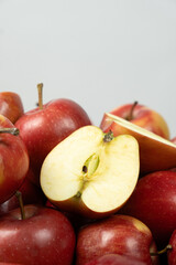 Group of fresh red whole apples and apple halves close-up.