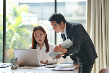 Asian office employee supervising Mentor training trainee at office