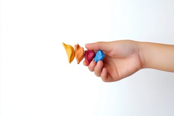 hand holding a colorful clay 