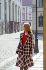 young beautiful woman in vintage suit in european city