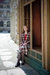 young beautiful woman in vintage suit in european city