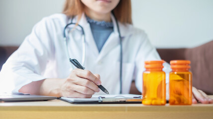 The female doctor sat and checked the patient's history and used a laptop to record patient information at the hospital. Medical concepts and interests