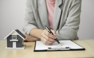 cagents working in real estate investment and home insurance signing contracts in accordance with the home buying insurance agreements approving purchases for clients