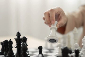 hand of businessmen moving chess in competition shows leadership, followers and business success strategies