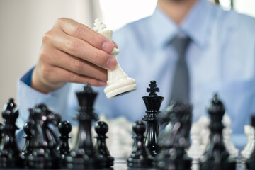 hand of businessmen moving chess in competition shows leadership, followers and business success strategies