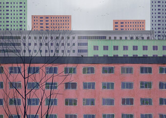 Multi-colored houses standing next to each other. Dense buildings and trees in the city. Brick, gray and green. Autumn drawing