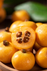 Ripe loquats fruit on wooden table.