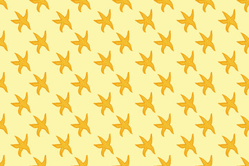 Seamless pattern with yellow and orange starfish on a yellow background. Summer sea background.